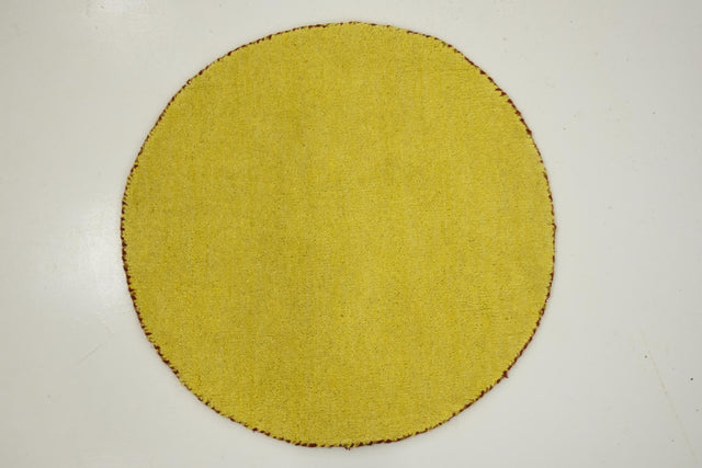 Yellow 2' 4 x 2' 4 Solid Gava Round Area Rug 100% High Quality All Natural Wool Minimalist Carpet for Modern Home Interior Design for Sale at Rug Engine