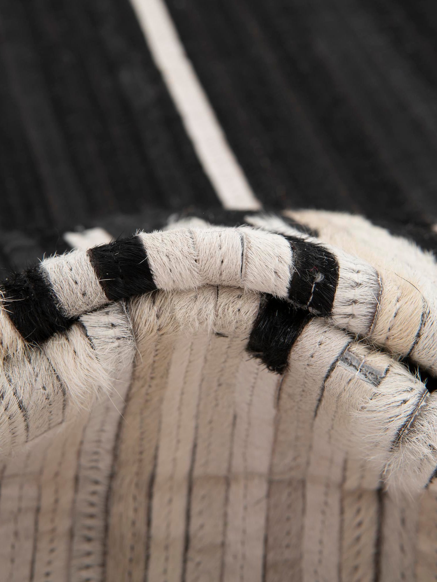 Authentic Luxury Black White 4' 1 x 4' 1 Cowhide Leather Round Area Rug Modern Interior Design 100% Real Natural Cowhide Carpet for Designer Home Decor for Sale at Rug Engine